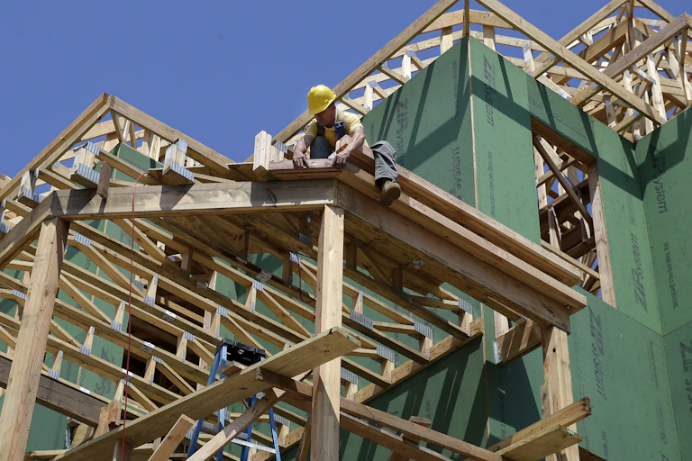 Man in hard hat works on construction site