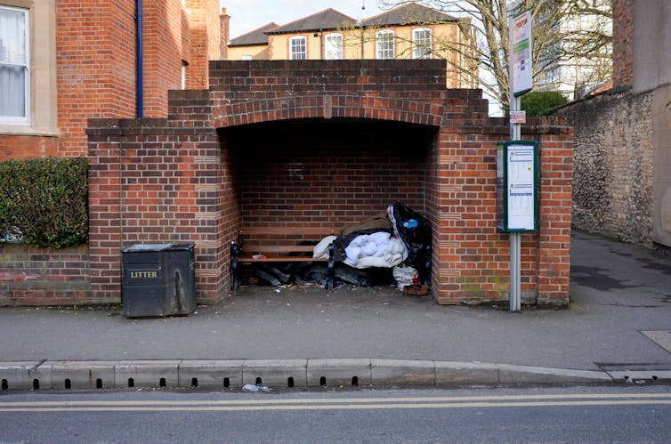 Rough sleeping in a brick bus shelter