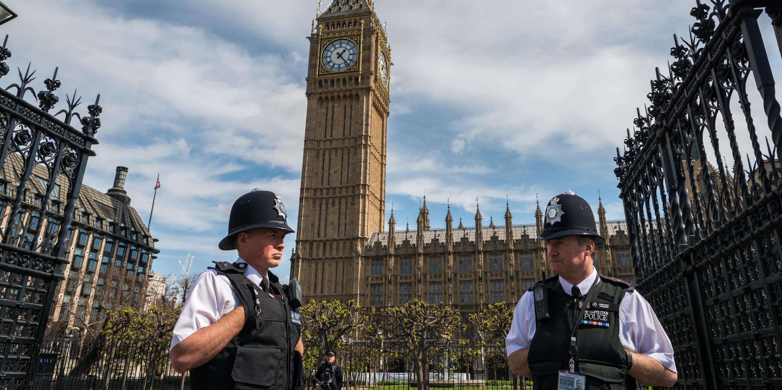 Two London police officers standing in front of Westminster palace