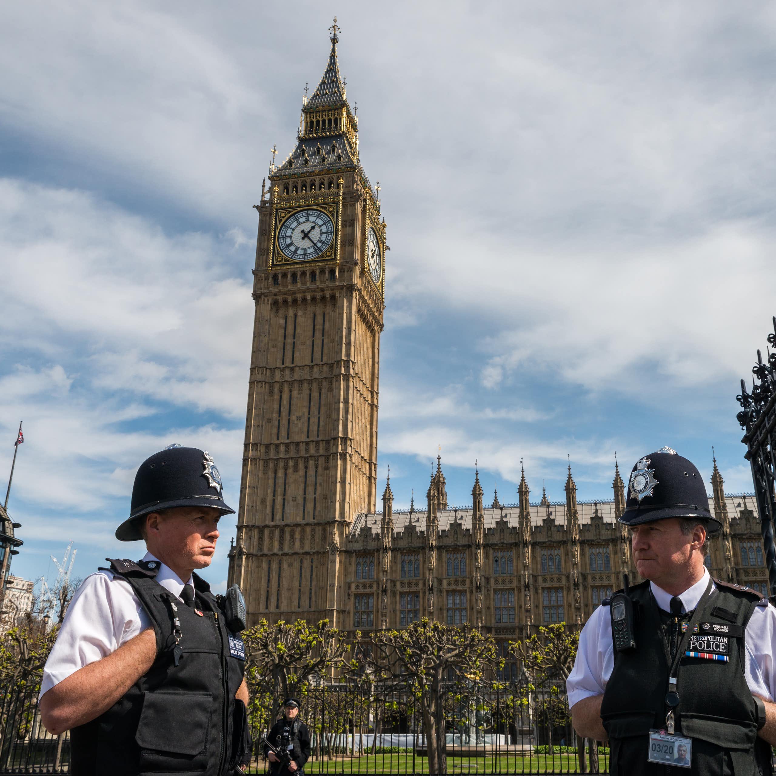 Two London police officers standing in front of Westminster palace