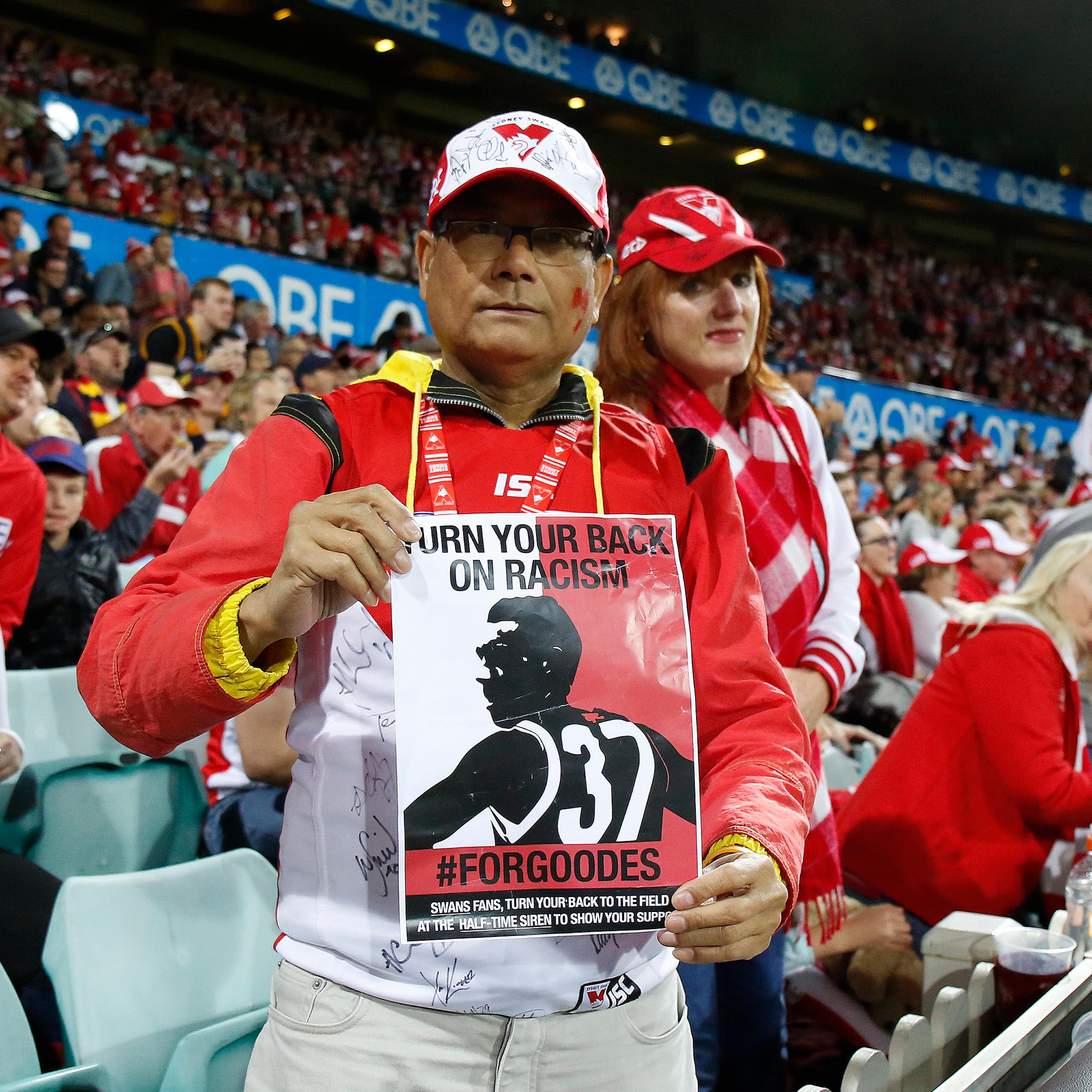 A Sydney Swans fan holds a leaflet in support of Adam Goodes in 2015