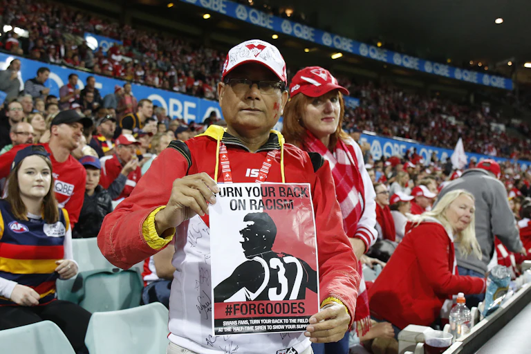 A Sydney Swans fan holds a leaflet in support of Adam Goodes in 2015