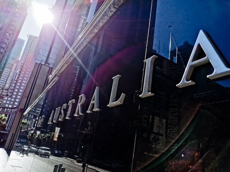 Reserve Bank of Australia name on black granite wall in Sydney Australia with lens flare