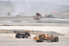 Trucks drive across the construction site <a href=