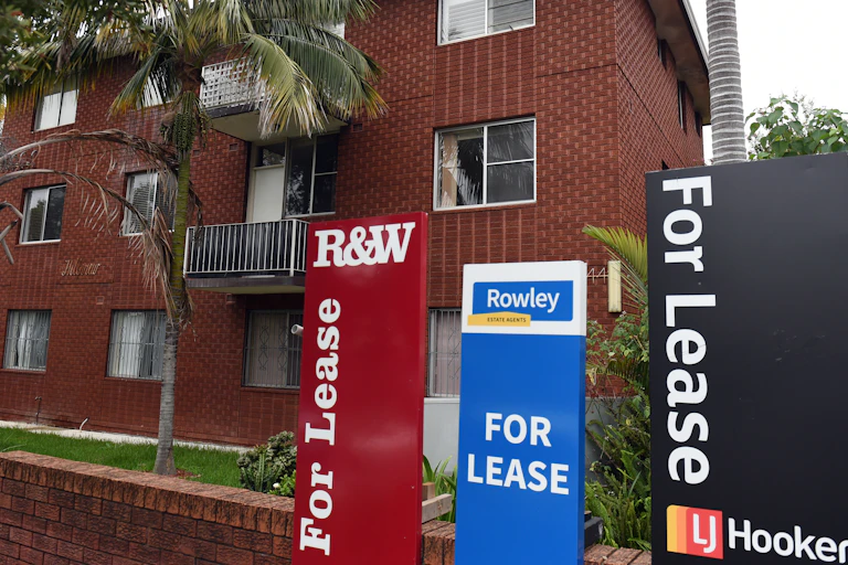 For least signs outside a brick apartment block.