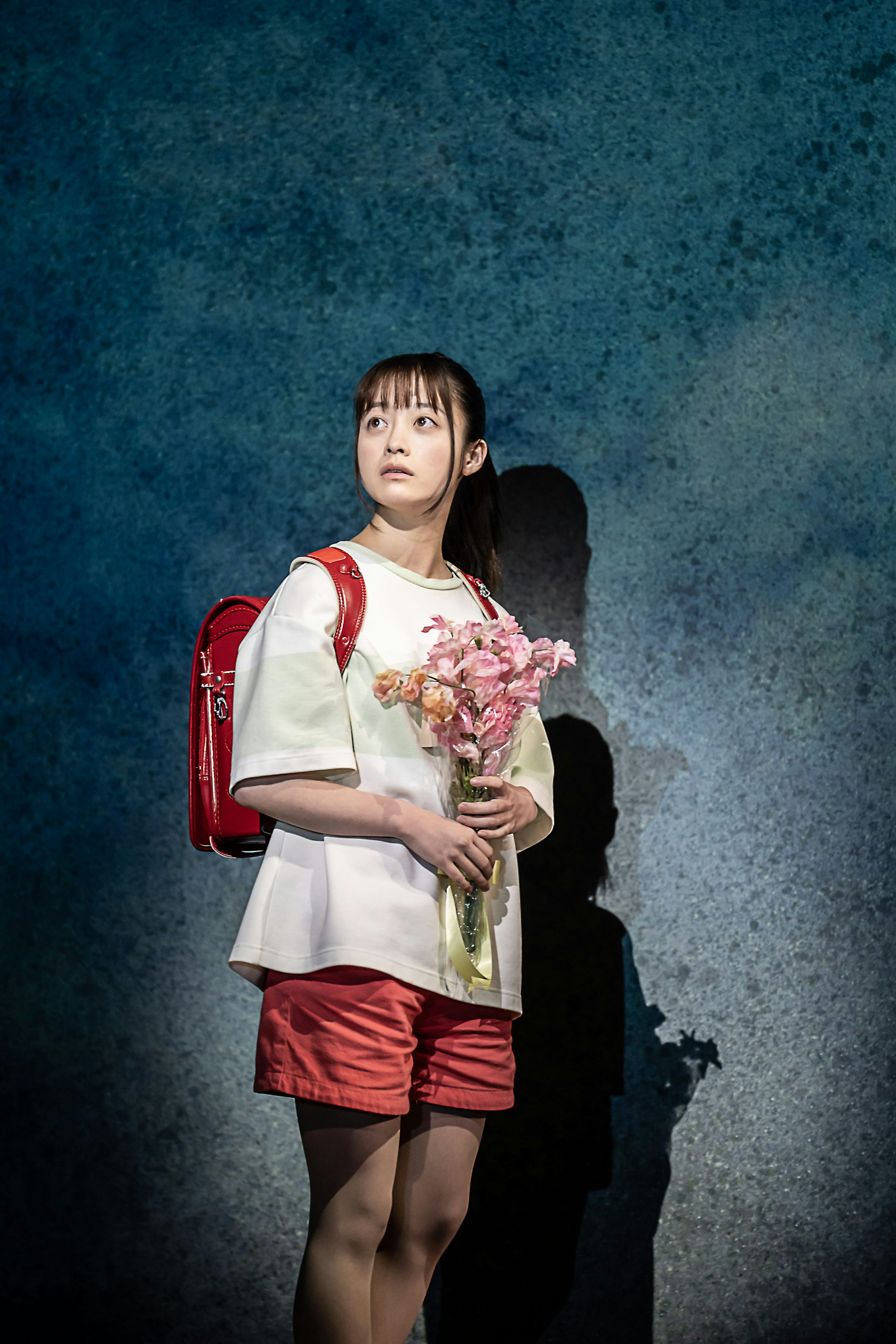 Girl with backpack and flowers.