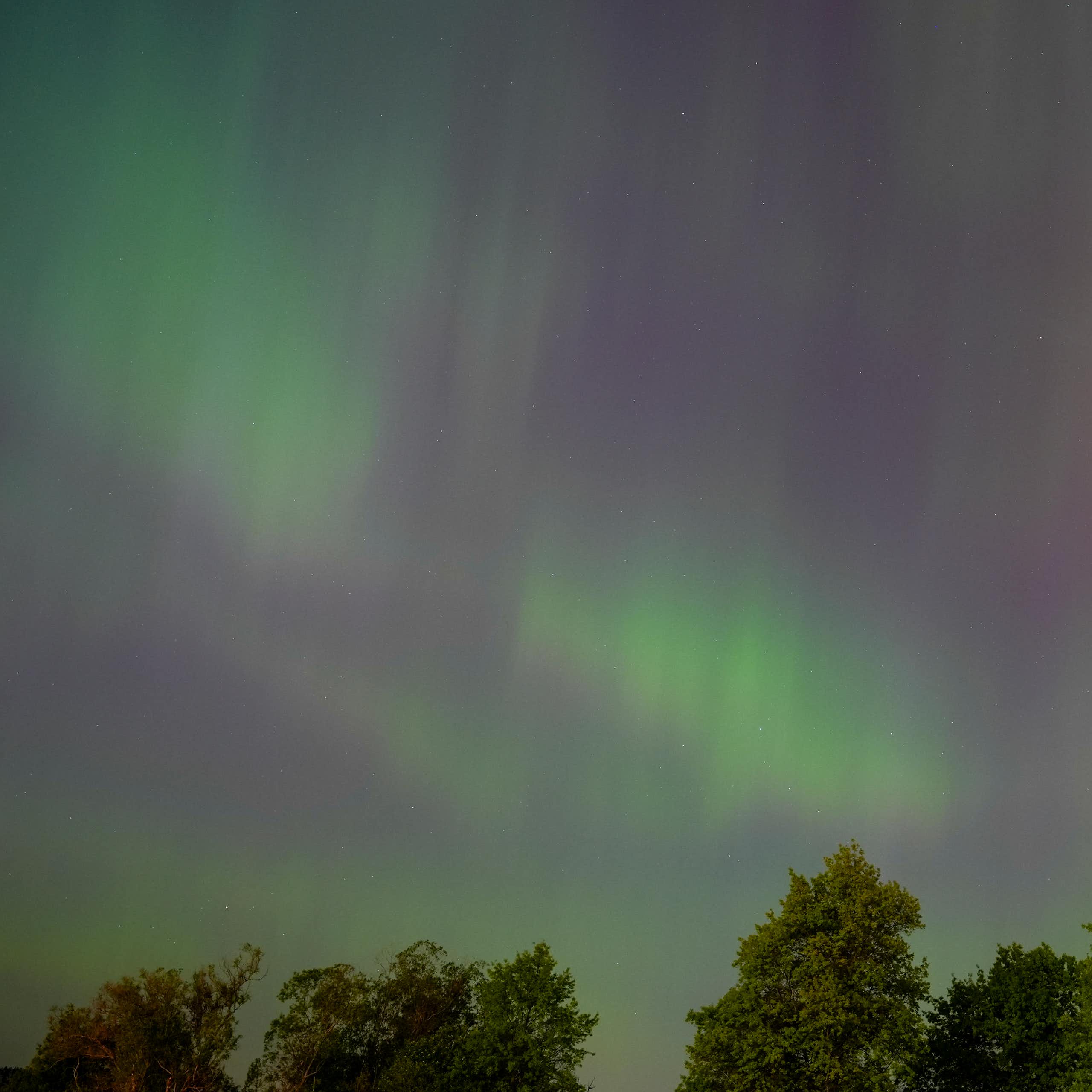 The northern lights, shown as green streaks of light across the sky.
