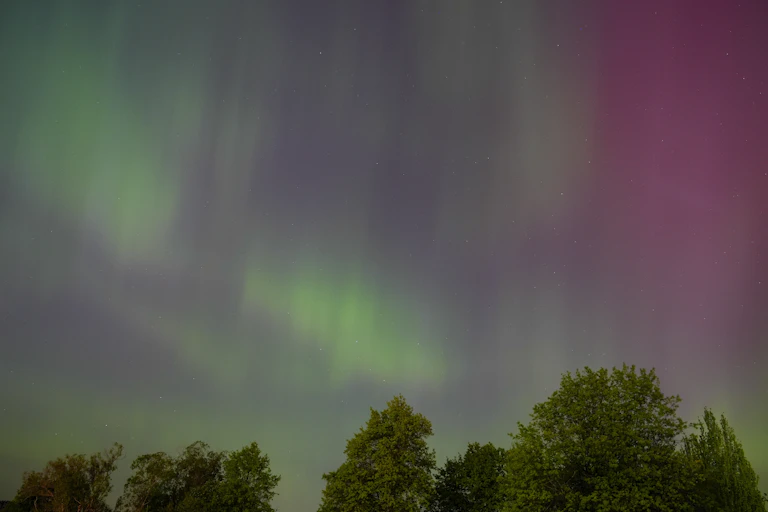 The northern lights, shown as green streaks of light across the sky.