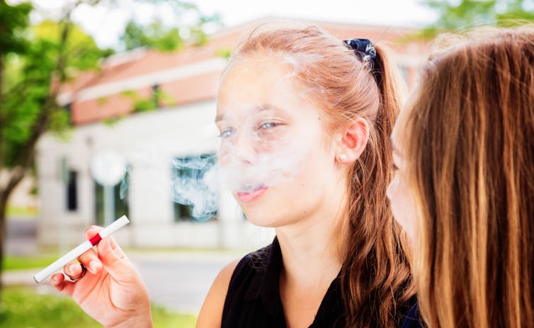 Teenagers using vapes