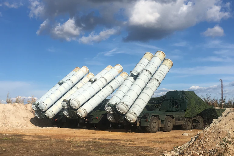 Photo of a large truck with several missiles on its back.