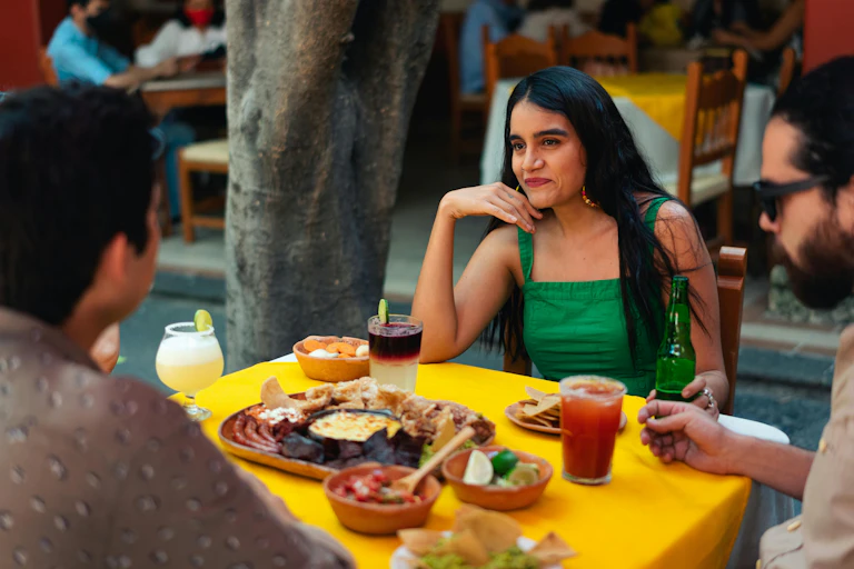 Woman sits at a table with her friends