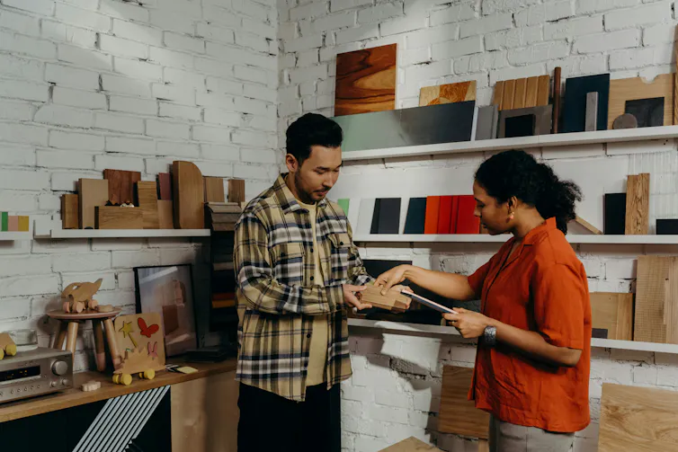Man selling book to woman