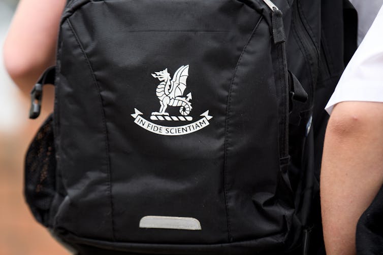 A black back with the white Newington school crest.