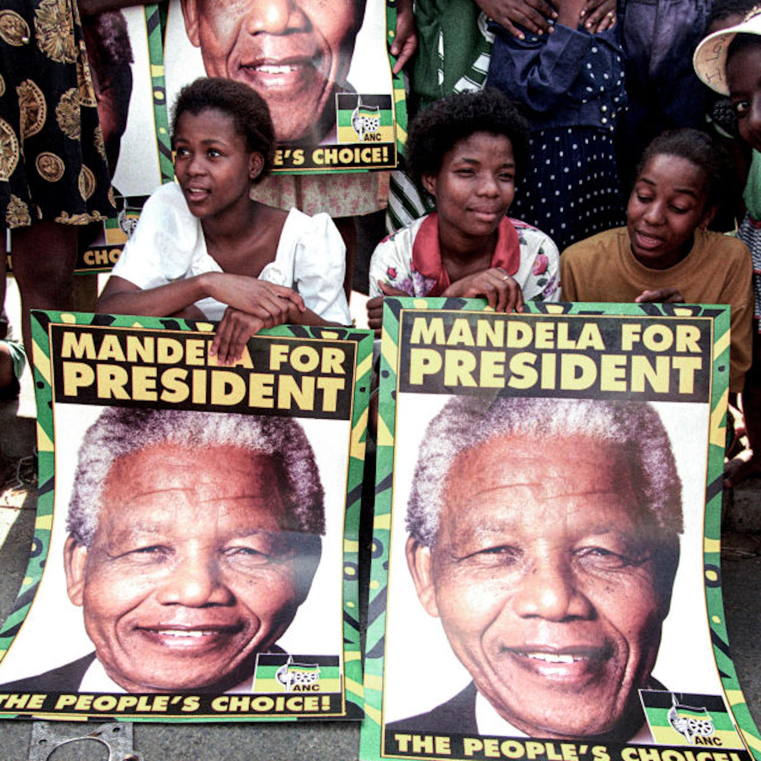 Young people pose with posters saying 'Mandela for president'. 