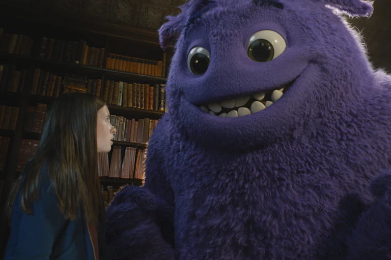 Image of girl with large furry purple creature