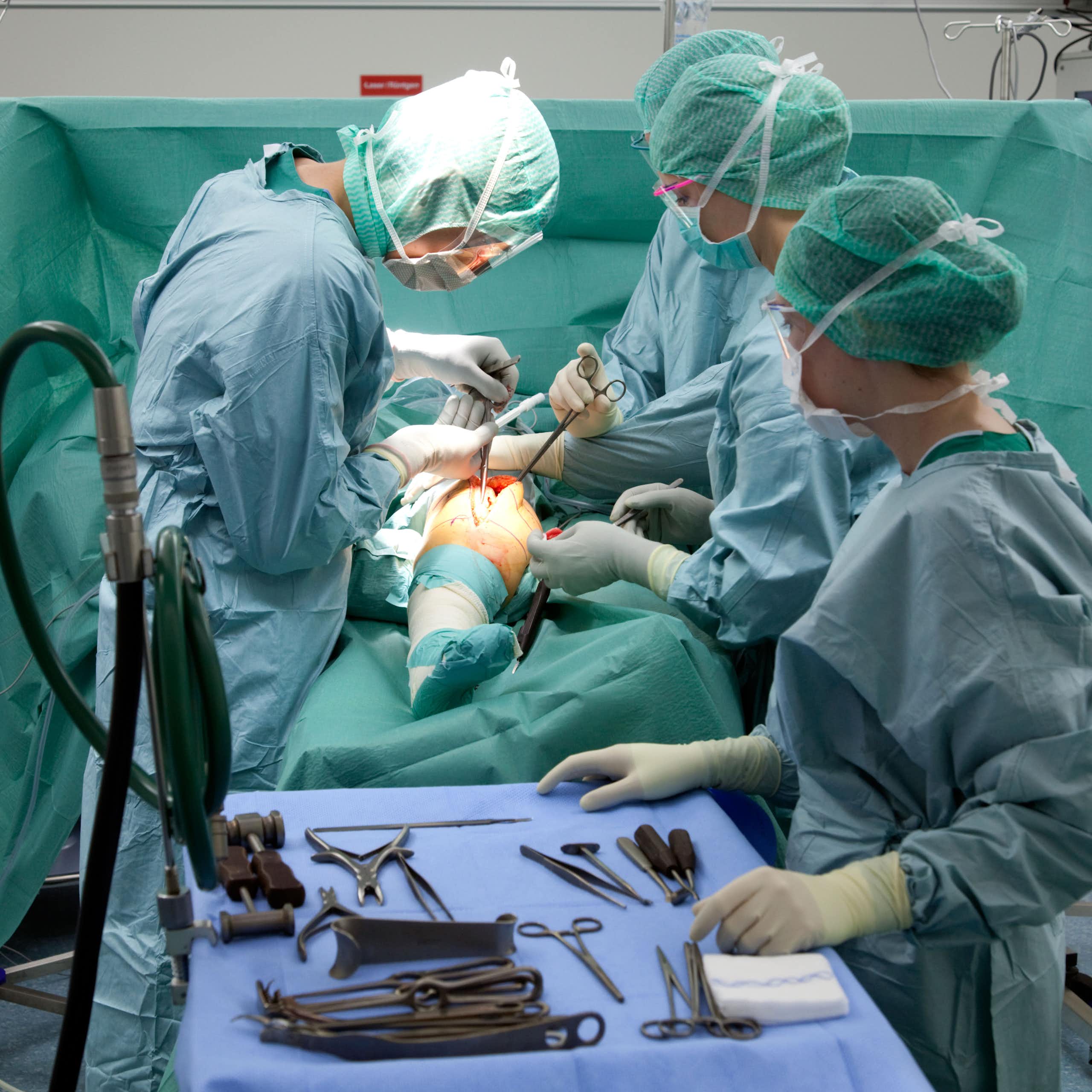 Surgeons performing knee surgery
