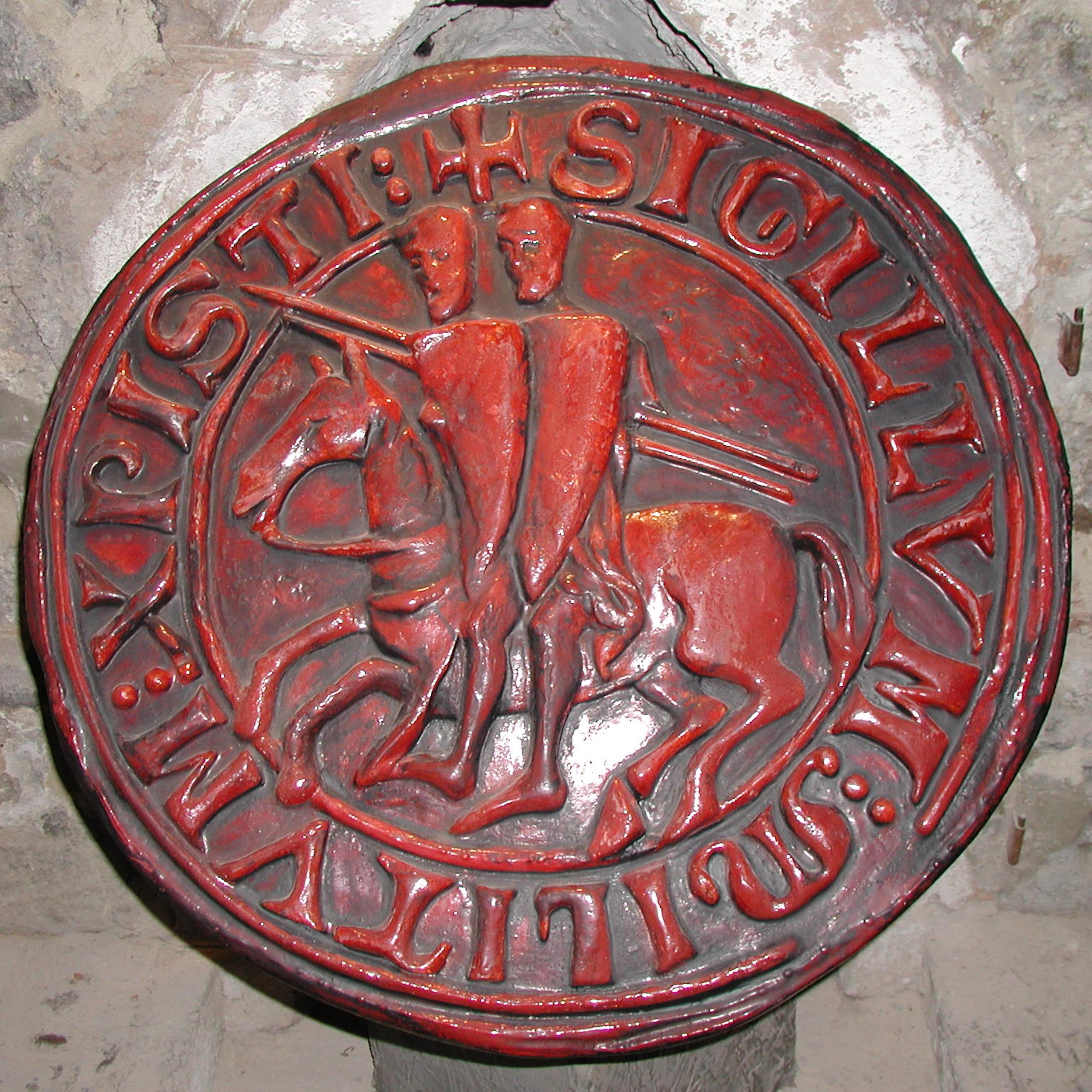 Circular, red seal depicting two knights sitting on one horse