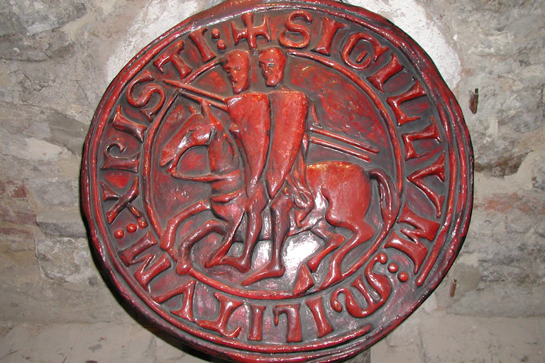 Circular, red seal depicting two knights sitting on one horse