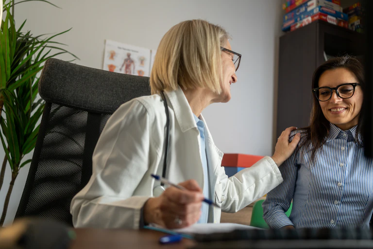 Doctor seeing patient in doctor's office.