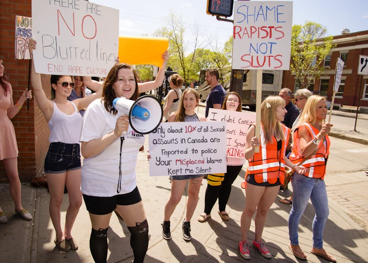 a group of women protesting rape culture and holding placards