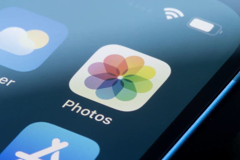 close-up of a rainbow-coloured floral icon on a smartphone