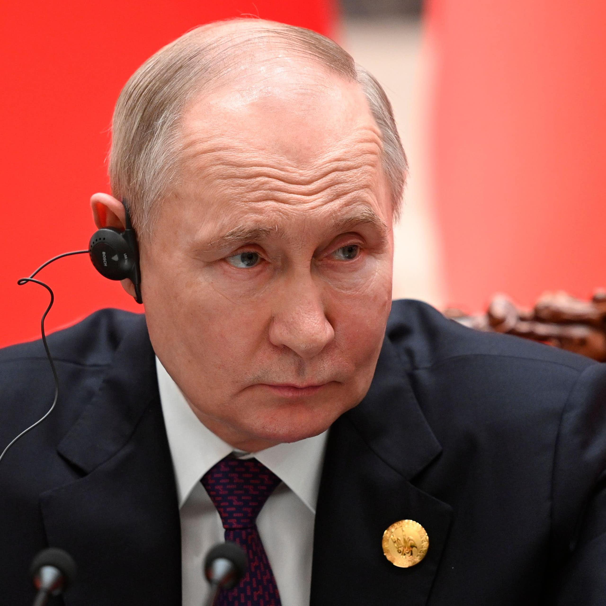 Vladimir Puttin with a headphone on.