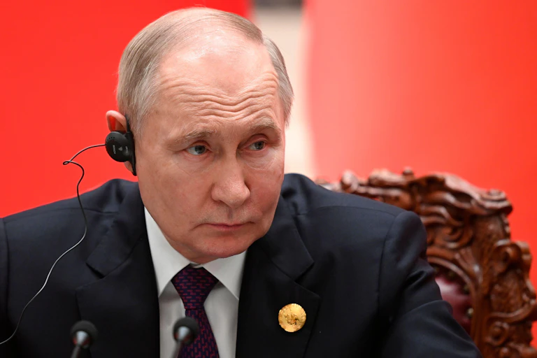 Vladimir Puttin with a headphone on.