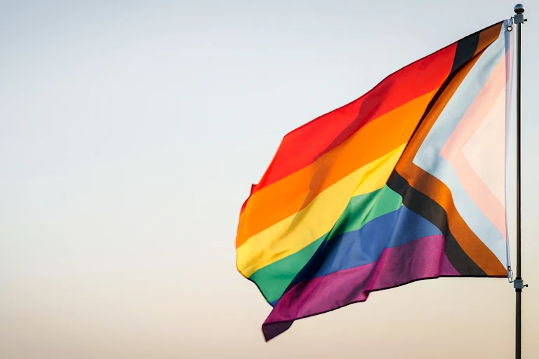 A rainbow flag on a pole