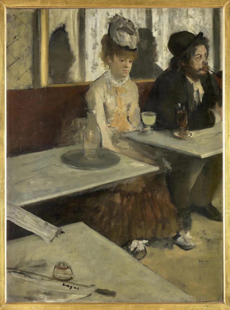 An Edgar Degas painting of a befuddled-looking woman sitting in a bar with a glass of absinthe in front of her.