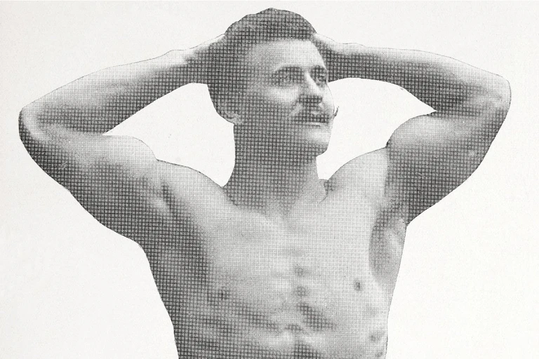 A black and white image of a man with a moustache, shirtless and muscular, his hands behind his head.