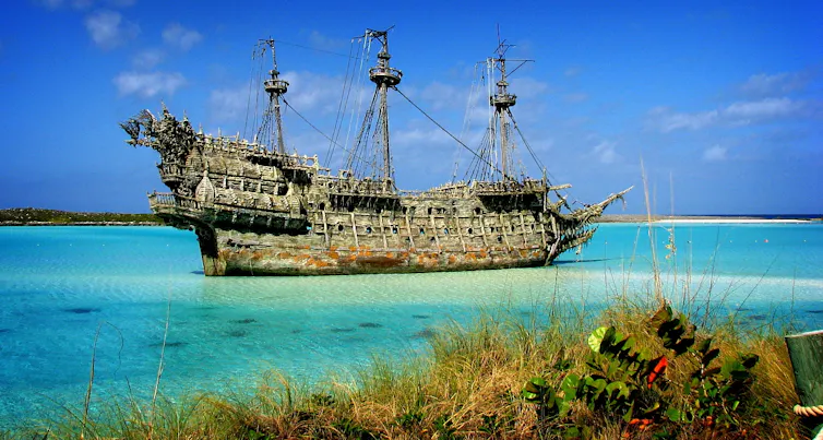 A large tall ship in a blue sea.