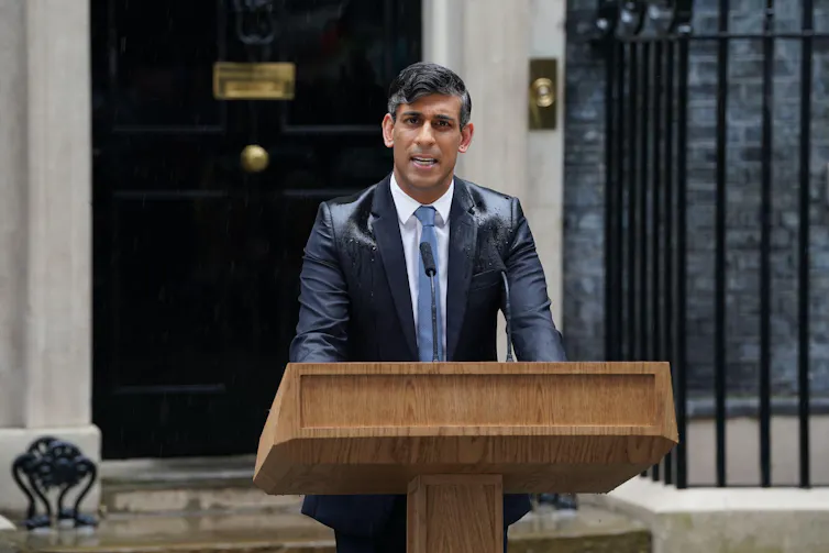 Rishi Sunak making a speech in the rain