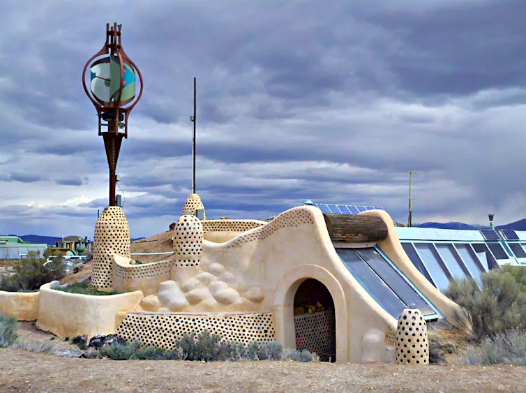 A stone-washed desert home with solar panels.