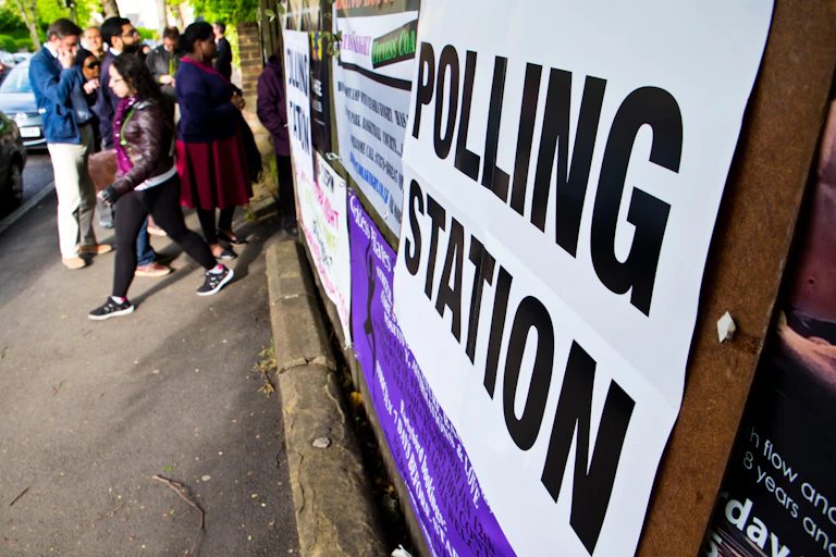 People gathering outside a polling station.