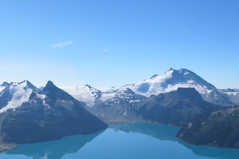 A lake is seen amongst mountains.