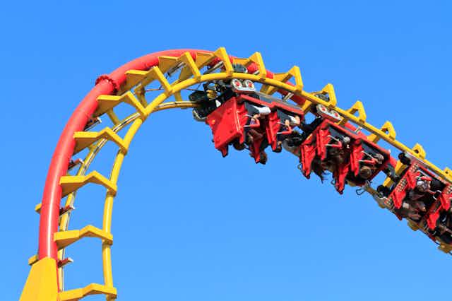 People upside on rollercoaster at top of loop