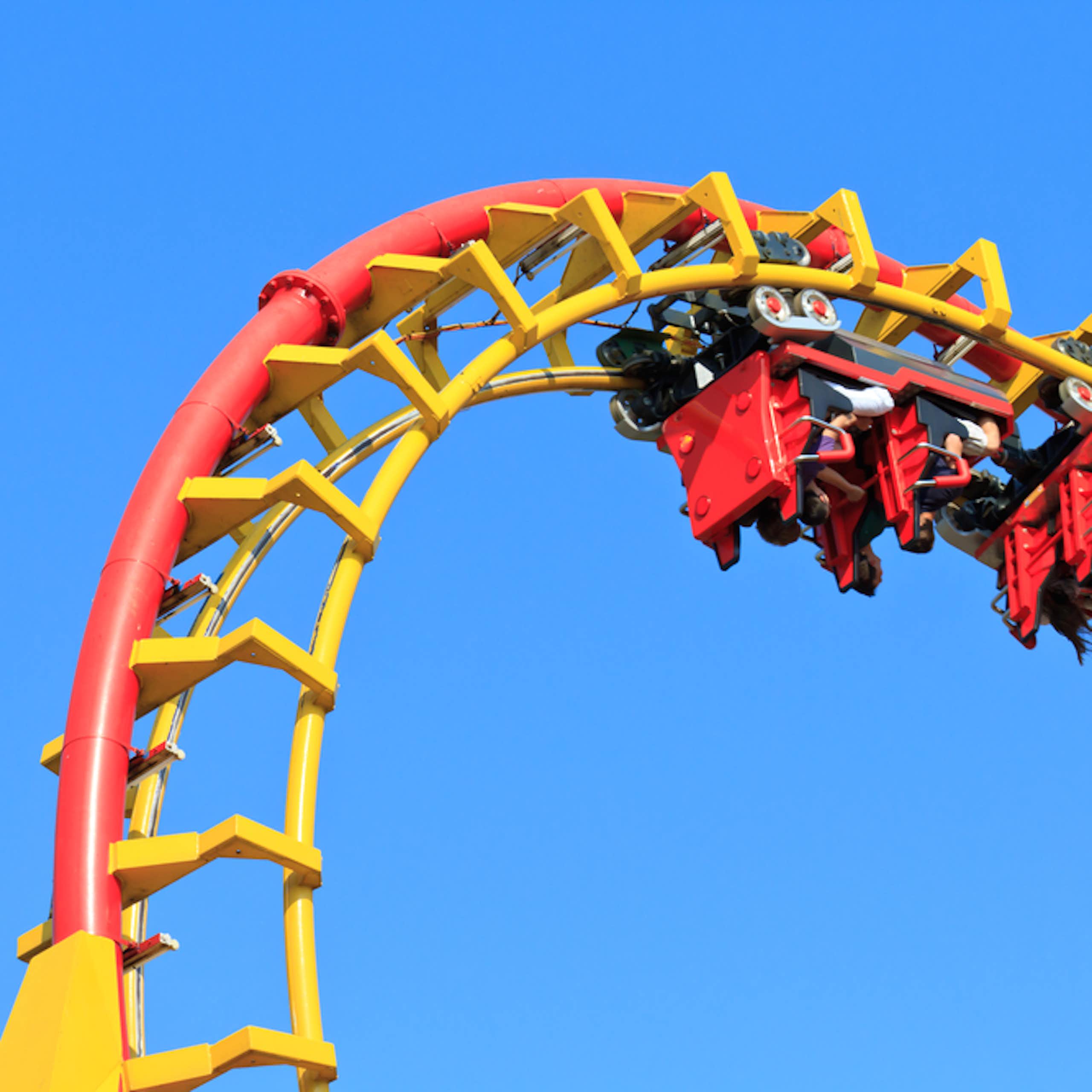 People upside on rollercoaster at top of loop