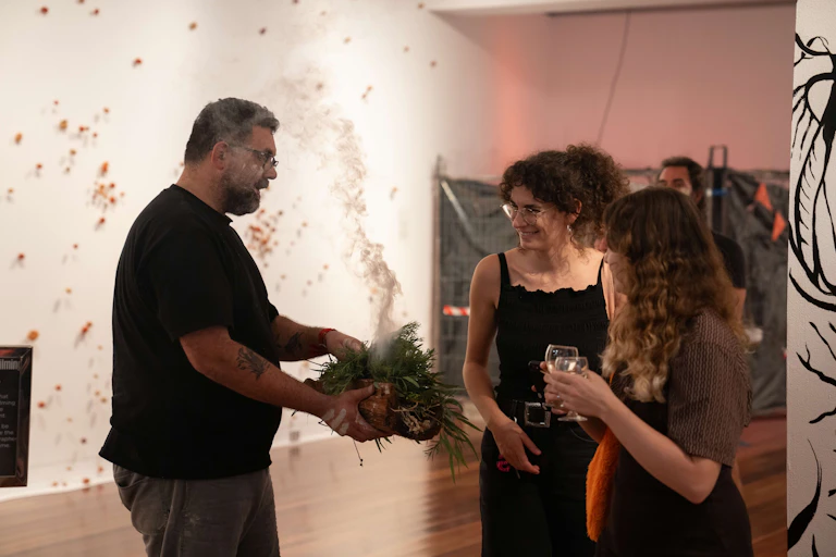 A smoking ceremony in a gallery.