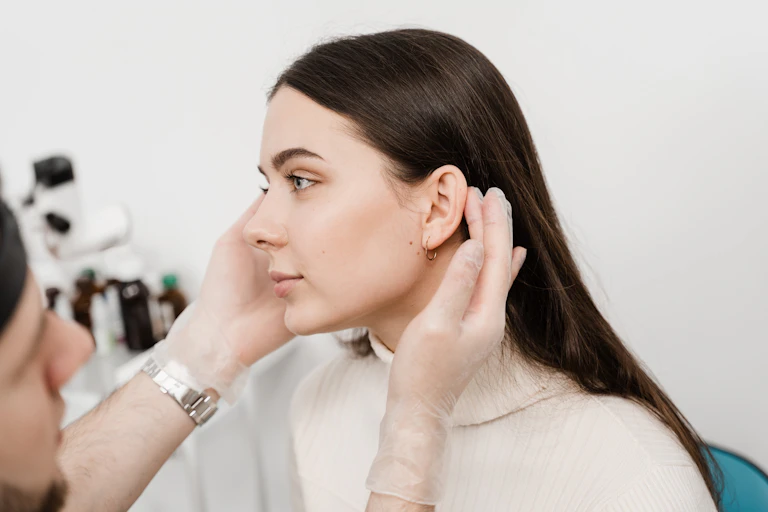 Woman having her ears examined by a doctor