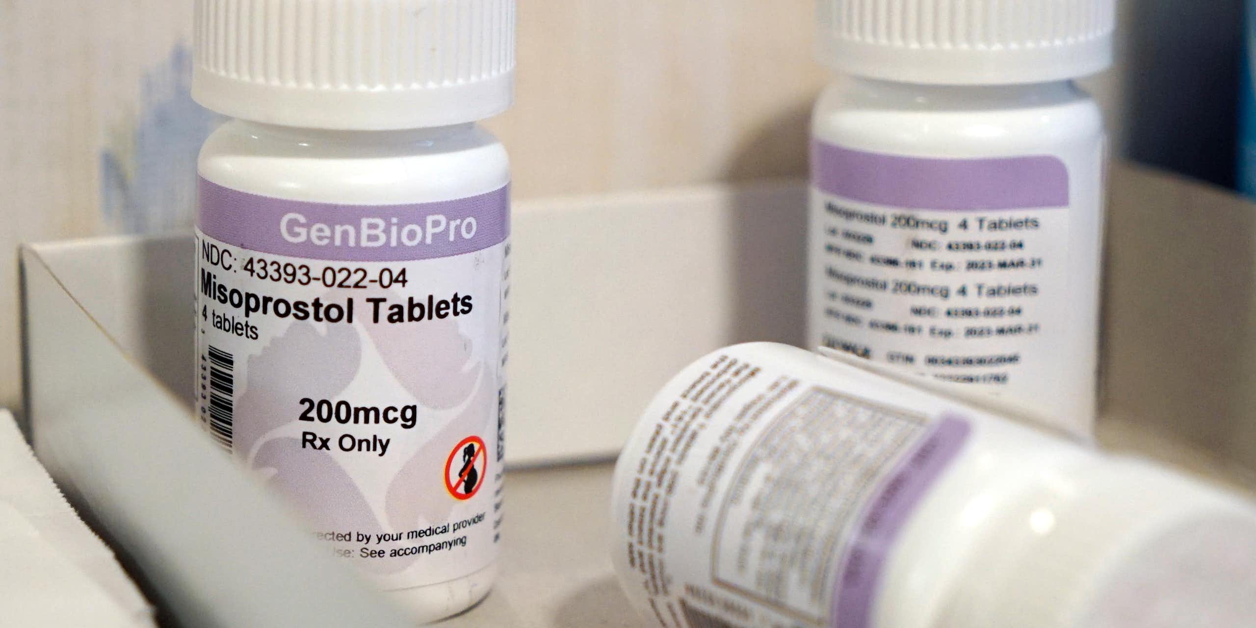 Three bottles of misoprostol tablets are displayed