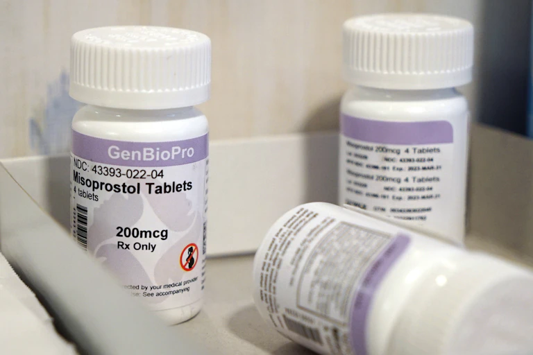 Three bottles of misoprostol tablets are displayed