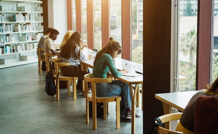 Students sitting in a library.