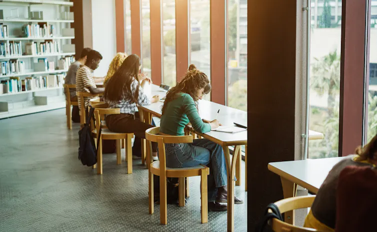 Students sitting in a library.