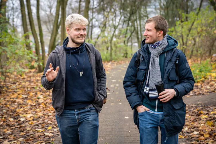 Two men walking in a park