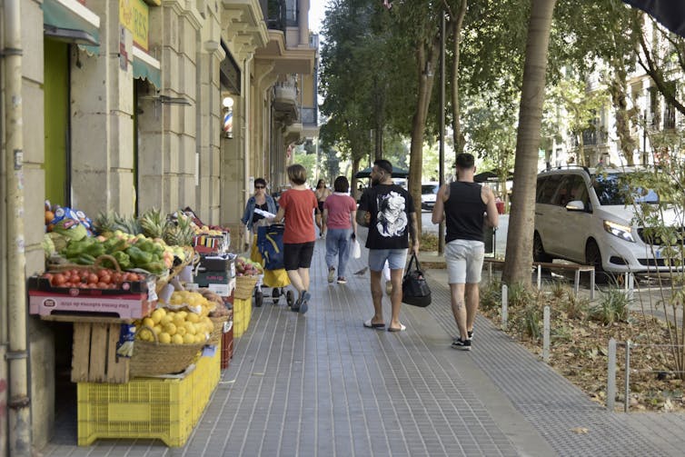 People walking along shops in Barcelona.