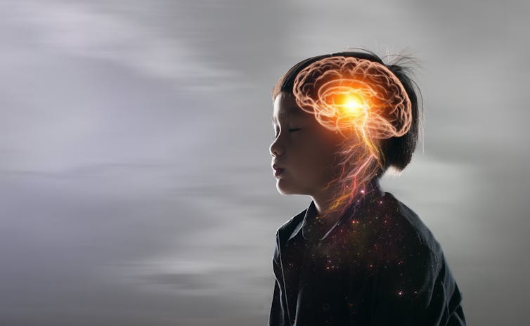 image of boy sitting with diagram of gold brain superimposed over image