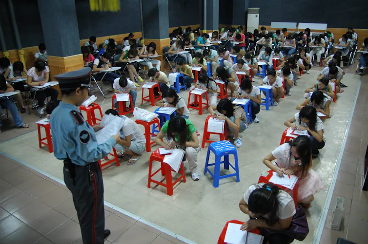 Workers sitting a test in a Chinese factory.