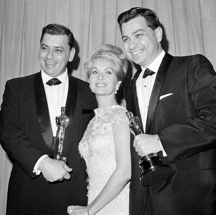 Two men and Debbie Reynolds.
