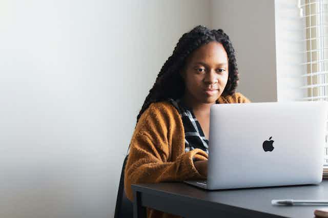 A woman on a laptop.