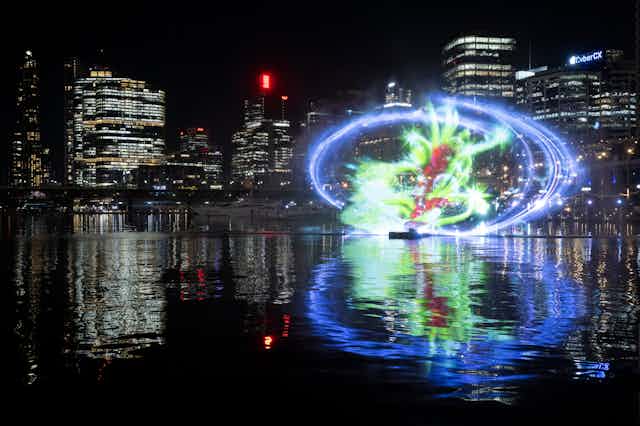 Glowing light art installation against city backdrop